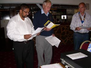 Lion Clif Cane reading out the Lions Code of Ethics to prospective member James Balasundaran,with Lion president Martin Fairley